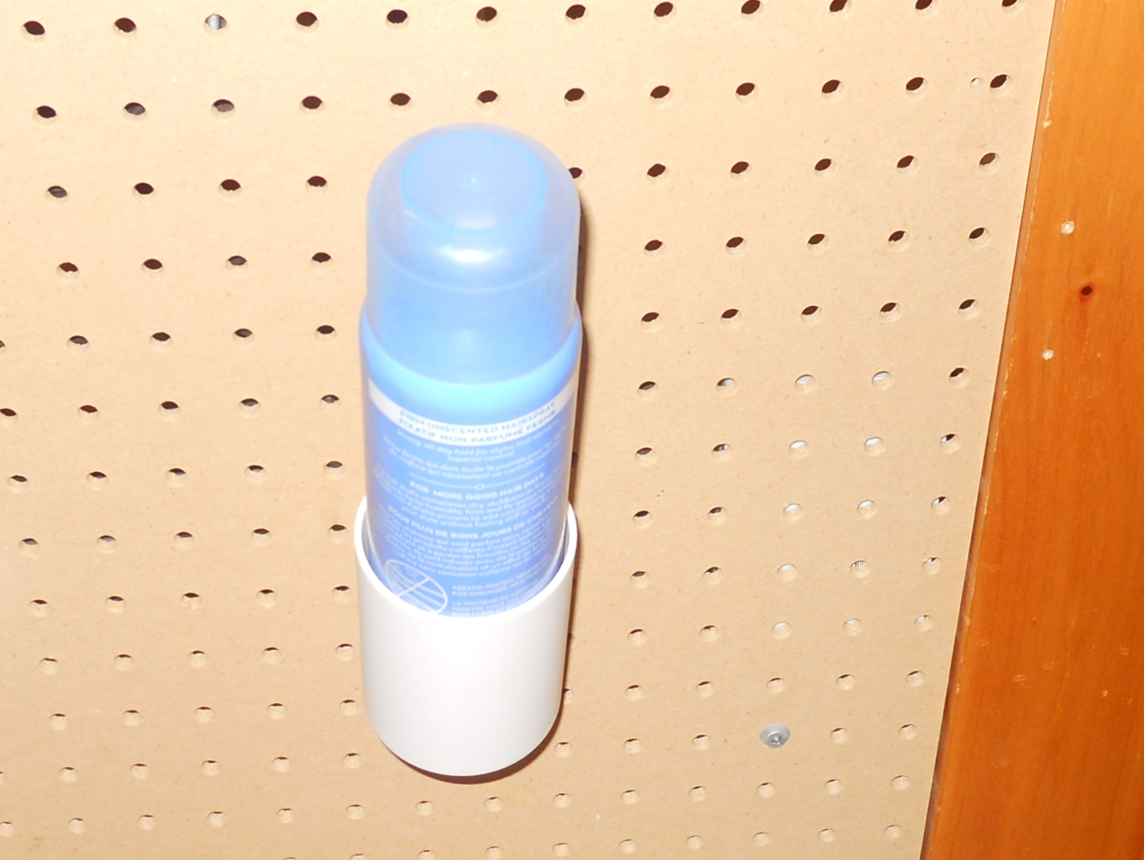 Spray can holder for pegboard